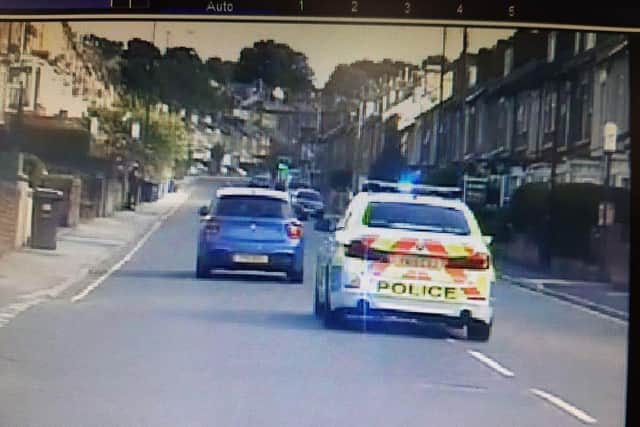 Police pursue the stolen BMW on City Road.
