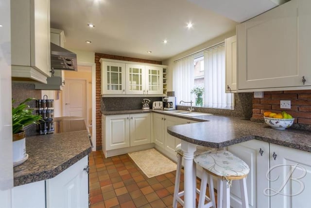 The nice kitchen comes complete with a range of matching units and cabinets, plus breakfast bar, inset sink and drainer, integrated dishwasher, oven with electric hob and stainless-steel cooker hood. There is also a breakfast bar and a door leading to the back garden.