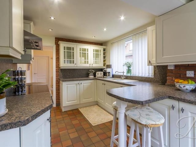 The nice kitchen comes complete with a range of matching units and cabinets, plus breakfast bar, inset sink and drainer, integrated dishwasher, oven with electric hob and stainless-steel cooker hood. There is also a breakfast bar and a door leading to the back garden.