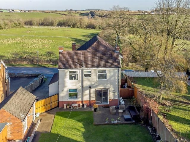 This view from a drone underlines the delightful rural setting of the Buttery Lane property. The countryside spreads far and wide across the road from the front of the house.