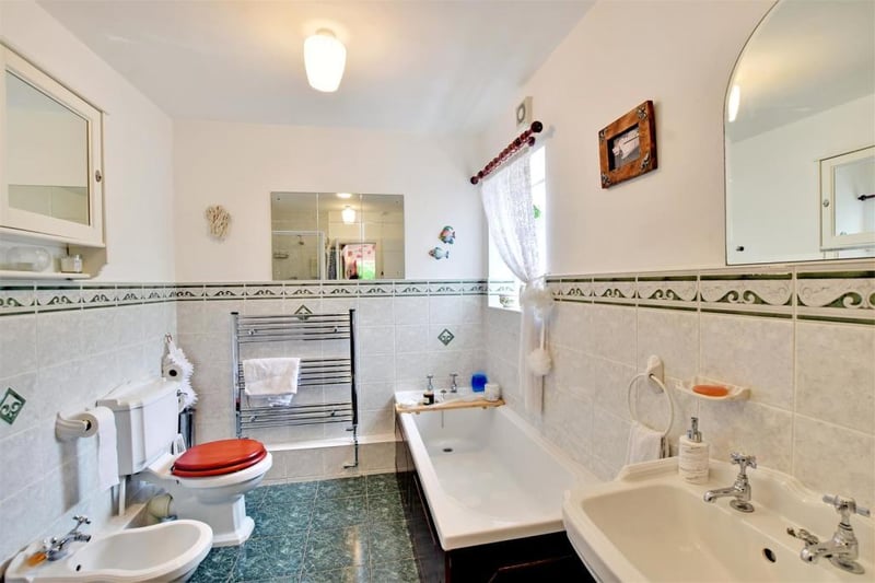 The bathroom features a low level WC, bidet, pedestal wash hand basin, panelled bath and corner shower cubicle