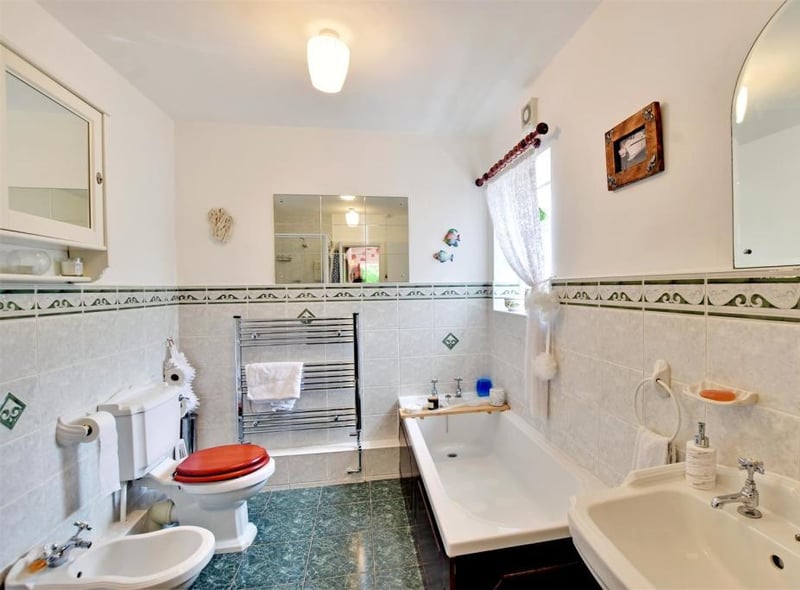The bathroom features a low level WC, bidet, pedestal wash hand basin, panelled bath and corner shower cubicle