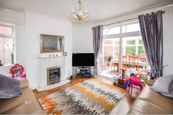 In the dining room is a fire surround housing the gas fire, window to the side and coving to the ceiling.  A sliding door leads into the conservatory.