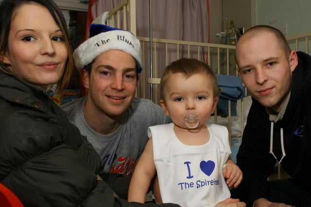 Defender Aaron Downes with young Owen Chandler and his mum Gemma and Dad Craig in 2008.