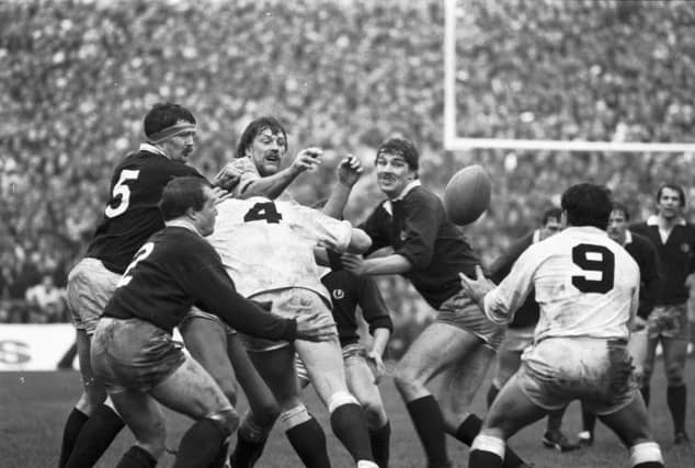 England's Steve Bainbridge gets the ball away during the Scotland v England Five Nations rugby match at Murrayfield in February 1984. After beating England to take the Calcutta Cup and beating Wales to win the Triple Crown, Scotland completed the Grand Slam by beating France 21-12.
