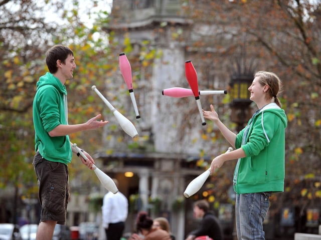 2011. Harry Cooper (22) and Siobhan Dolan (19) from the University of Portsmouth Society of Circus Skills entertain passers by in the Guildhall Square to raise money for Children in Need.
Picture: Steve Reid 114113-109