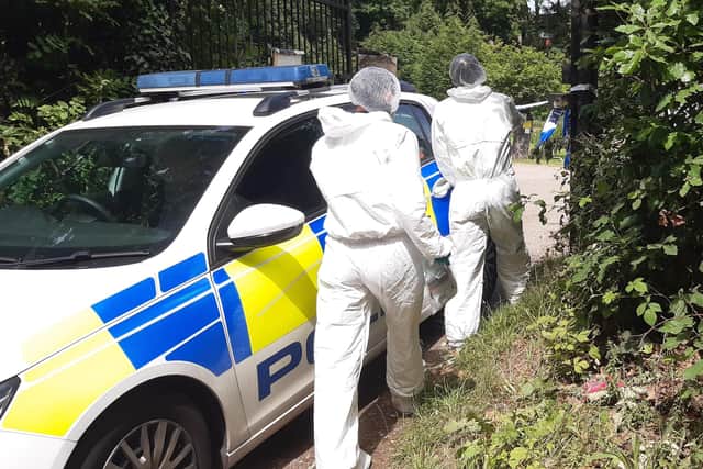 This is the scene at a Sheffield fishing lake near Shirecliffe today, as police conitinued a murder investigation.