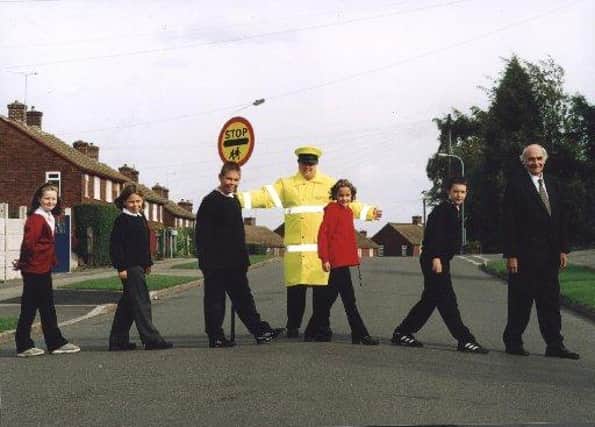 Brimington Junior School pupils support  International Walk To School Day in 2011. Kelsey Stirling, Eleanor Inman, Scott Cullen, Alice Brooks and Jason Mason are pictured with lollipop lady Trish Sinclair and Coun Walter Burrows.
