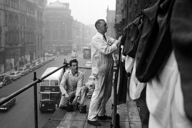 Workmen decorate the Scotsman Publications building on North Bridge in preparation for the King Olav of Norway's state visit to Scotland in October 1962.