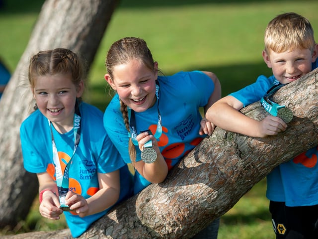 This trio of pals celebrate together after completing the Great South Run Junior race on Saturday. Photo: Peter Langdown