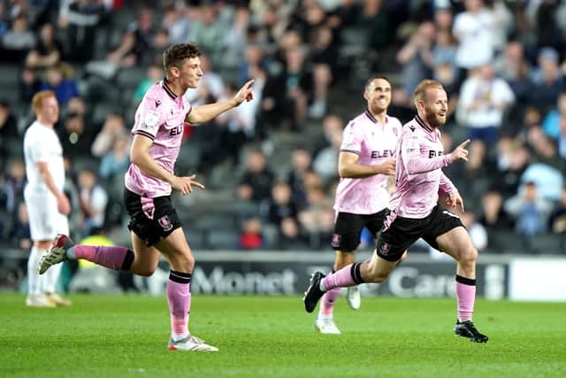 Sheffield Wednesday's Barry Bannan (right) celebrates scoring his side's third goal of the game with team-mates during the Sky Bet League One match at Stadium MK, Milton Keynes. Picture date: Saturday April 16, 2022.