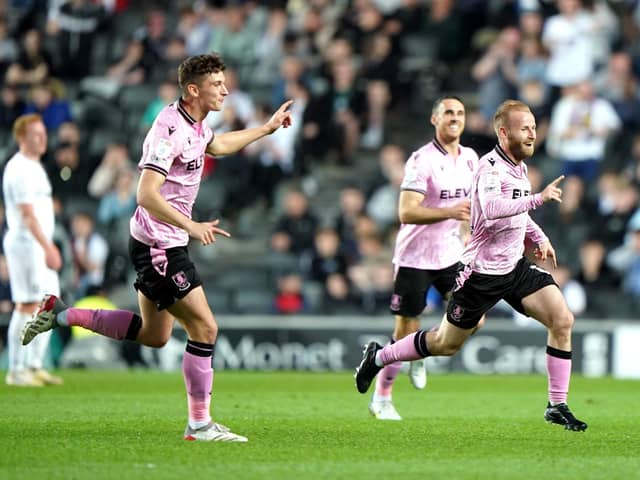 Sheffield Wednesday's Barry Bannan (right) celebrates scoring his side's third goal of the game with team-mates during the Sky Bet League One match at Stadium MK, Milton Keynes. Picture date: Saturday April 16, 2022.