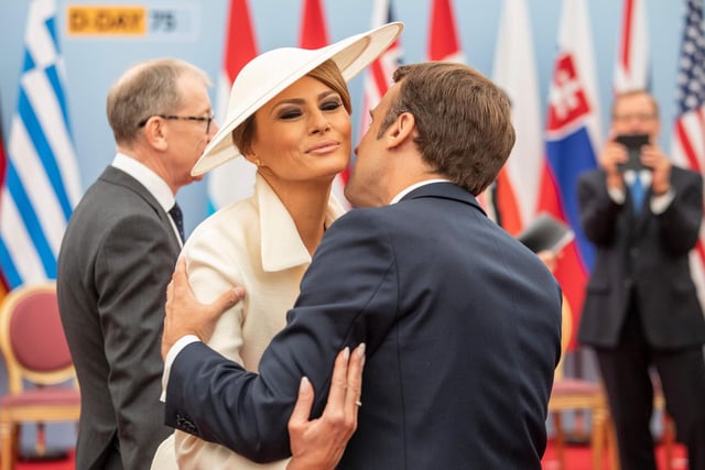 French President Emmanuel Macron kisses US First Lady Melania Trump in greeting as they attend an event to commemorate the 75th anniversary of the D-Day landings, in Portsmouth. Picture: JACK HILL/AFP/Getty Images