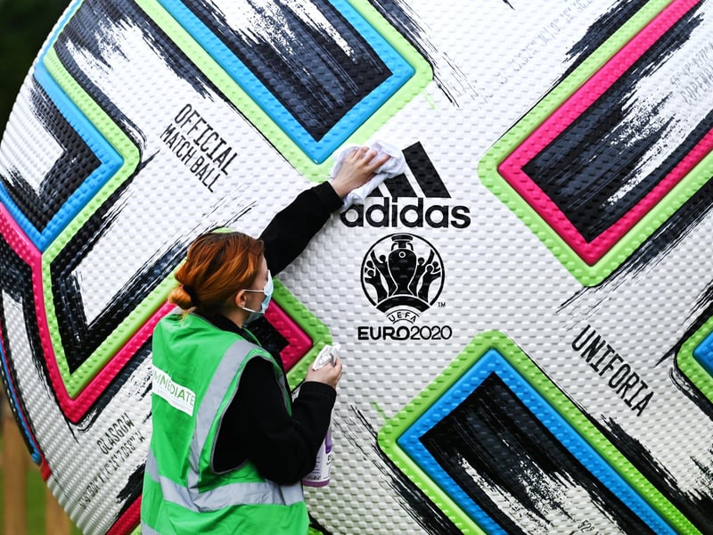 Justine Ralston clean the giant ball as finishing preparations are made in the area before opening.