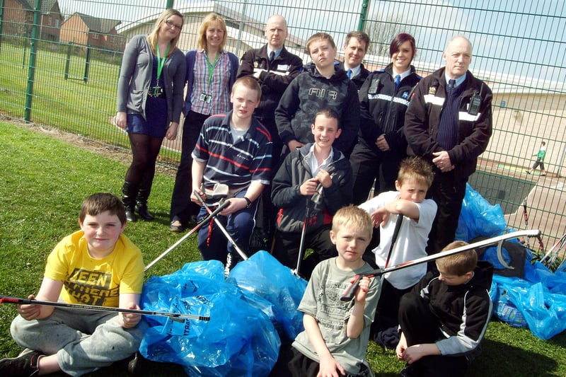 Westdale Lane beat officers with staff at the Oakdale Learning Centre and local schoolboys pictured after their clean-up of the area.