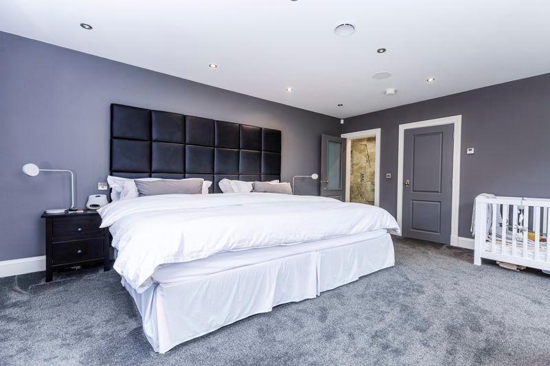 The master bedroom suite includes a large dressing room and ensuite bathroom.