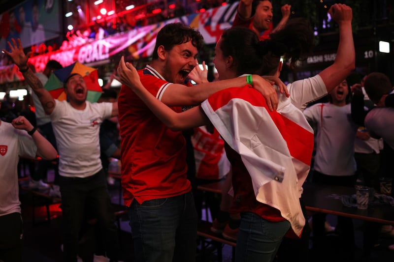 England fans cheer at BOXPARK Croydon as they watch a live broadcast of the semi-final match between England and Denmark.