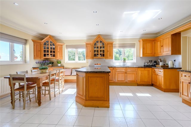 The spacious kitchen and breakfast room boasts solid oak fitted cupboards beneath a stylish black granite worktop, with a double oven Aga and separate hob and oven appliances.