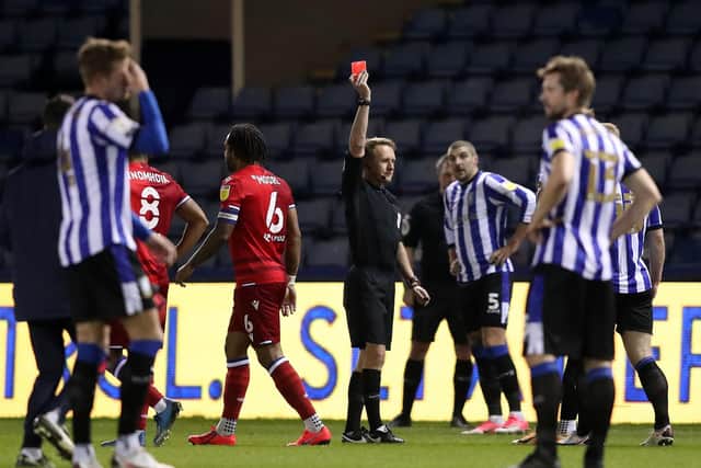 Liam Shaw of Sheffield Wednesday (obscured) receives a red card from Match Referee, Oliver Langford during the Sky Bet Championship match between Sheffield Wednesday and Reading at Hillsborough. (Photo by Alex Livesey/Getty Images)