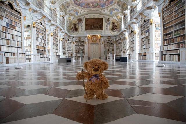 John James the teddy bear at a library in Styria, Austria. 
 These adorable teddy bears could be the world's most well-travelled cuddly toys - as their photographer owner has chronicled their adventures in 27 different countries. Christian Kneidinger, 57, has been travelling with his teddy bears, named John and Bob since 2014 - and his taken them to some of the world's most famous landmarks. The teddy bears have dressed up in traditional Emirati clothing to visit the Sultan's Palace in Oman, and have braved the cold on a glacier on Lofoten Island in Norway.