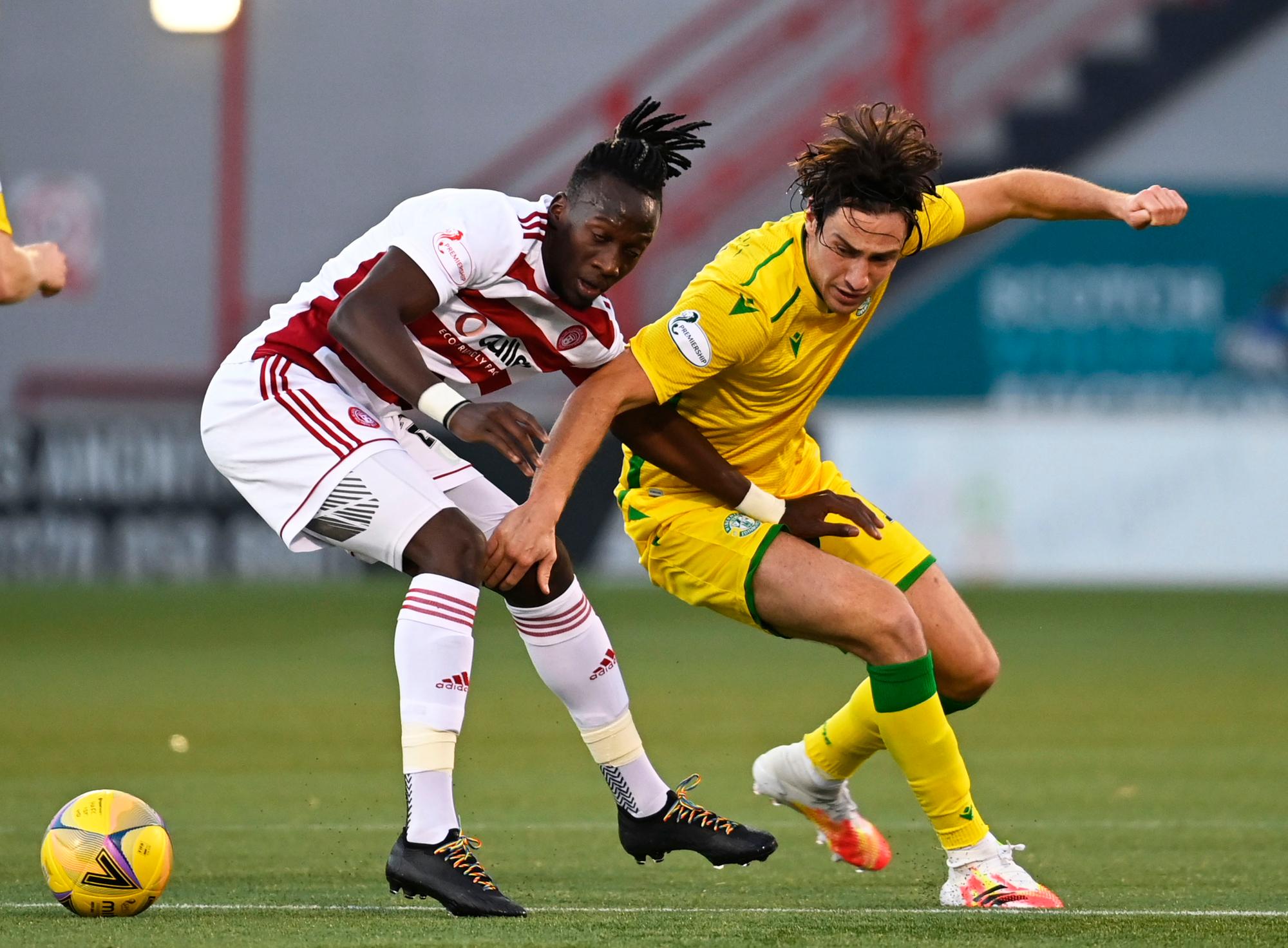 Joe Newell and David Moyo vie for the ball