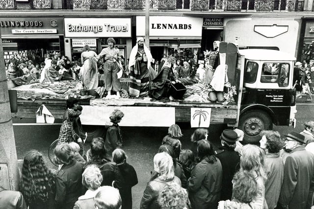 Crowds watch as one of the Sheffield Rag Day Parade floats passes the Town Hall, October 23,1976