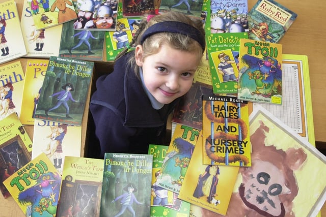 Lakeside Primary School, Sandy Lane, Belle Vue, has added to its collection of library books, thanks to abook competition run by Walkers Crisps and Asda. Our picture shows Caroline Clements, aged five, with the books and her competition painting in February 2001