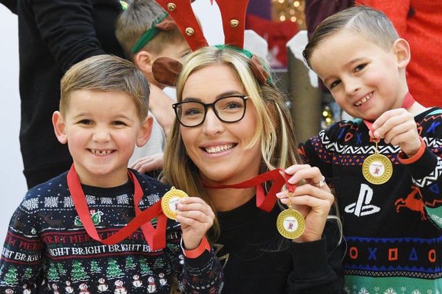 Regan Stewart from South Shields with her children Drew and Grayson proudly displaying their Reindeer Dash medals.