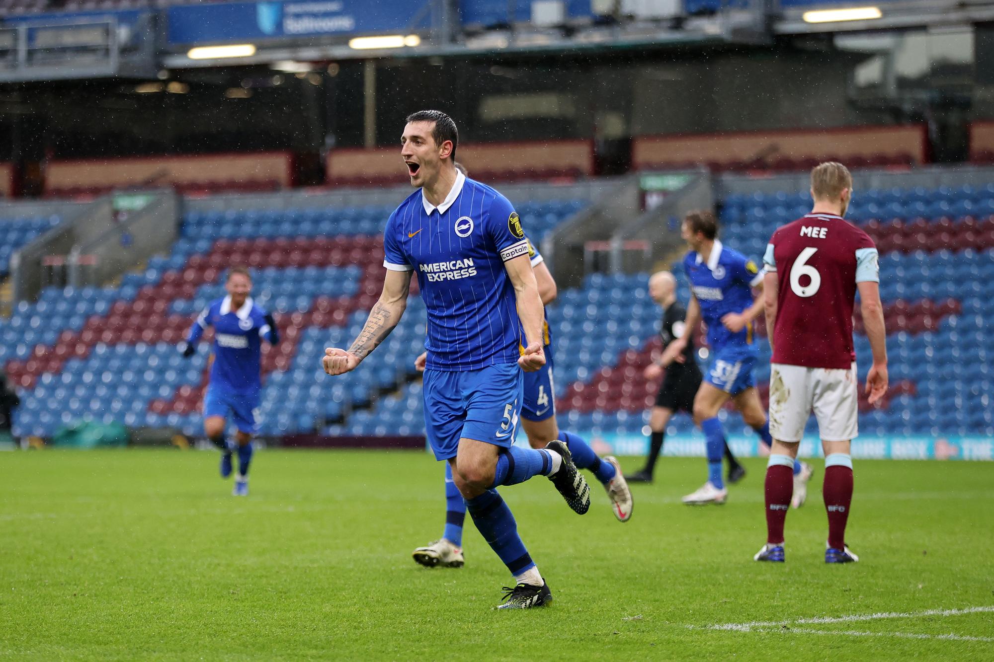 BURNLEY, ENGLAND - FEBRUARY 06: Lewis Dunk of Brighton and Hove Albion celebrates after scoring their side's first goal during the Premier League match between Burnley and Brighton & Hove Albion at Turf Moor on February 06, 2021 in Burnley, England. Sporting stadiums around the UK remain under strict restrictions due to the Coronavirus Pandemic as Government social distancing laws prohibit fans inside venues resulting in games being played behind closed doors. (Photo by Clive Brunskill/Getty Images)