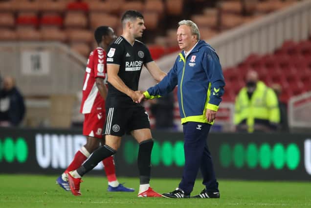 John Egan of Sheffield United shakes hands with Neil Warnock, manager of Middlesbrough: Simon Bellis / Sportimage