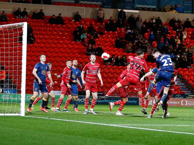 Mansfield Town defender Will Forrester grabs an equaliser.