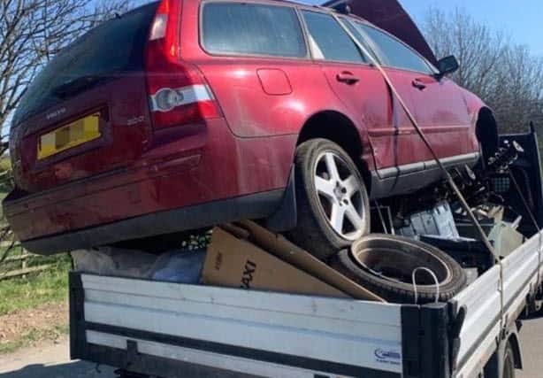 A car precariously balanced on the back of a scrap van was found by police during Operation Brigantia.