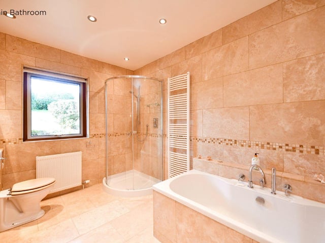The main bathroom has a stand alone shower and bath.