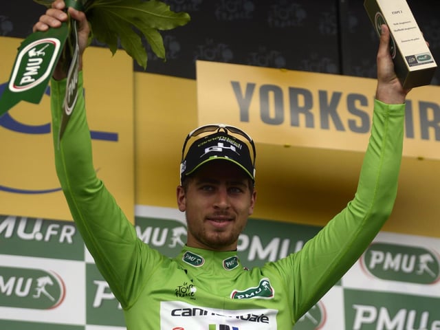 Peter Sagan celebrates winning the green vest on his victory in Tour de France 2014 Stage 2 after he crossed the finish line at  Sheffield Motorpoint Arena