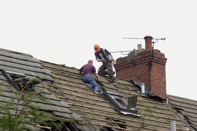 Workmen removed roof slates as the demolition of empty house in Edlington got underway in 2001