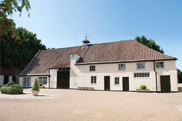 A range of outbuildings are located amid the large grounds, including the Grade II listed Tithe Barn.