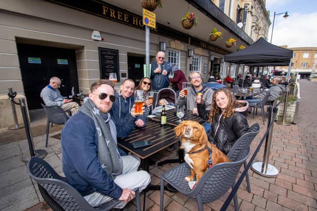 Jerome Matthews, Jasmine the dog, Derek Smith, Selma Matthews, Kaylan 2, Alister English and Sienna Matthews 11 outside The Lord Palmerston, Palmerston Road, Southsea on 12 April 2021. Picture: Habibur Rahman