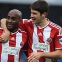 Sheffield United's Jamal Campbell-Ryce (left) and Ryan Flynn celebrate after beating QPR 3-0 at Loftus Road: Nigel French/PA Wire