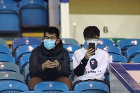 Fans wear a disposable face mask prior to the FA Cup Fifth Round match between Sheffield Wednesday and Manchester City at Hillsborough on March 04, 2020 in Sheffield, England. (Photo by Alex Livesey/Getty Images)