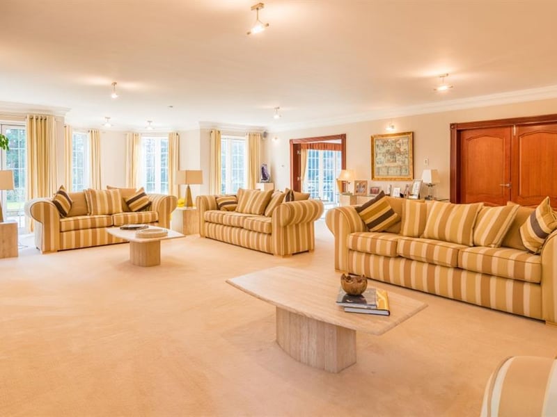 The grand living room provides plenty of living space and is bathed in light from the dual aspect windows, and two sets of French doors which lead out to the south facing sun terrace.
