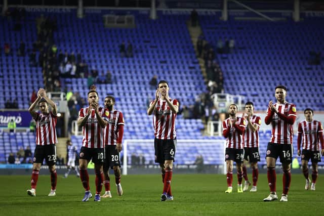 Chris Basham (centre) leads the applause of Sheffield United's travelling supporters after victory at Reading (Photo by Ryan Pierse/Getty Images)