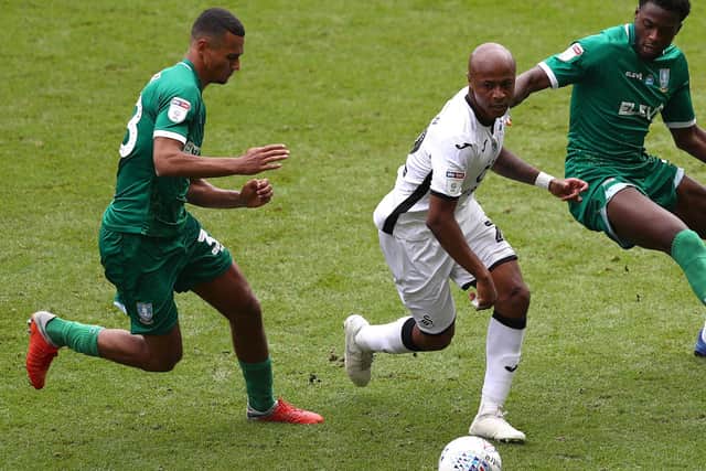 Alessio Da Cruz bounds down on Swansea City forward Andre Ayew.