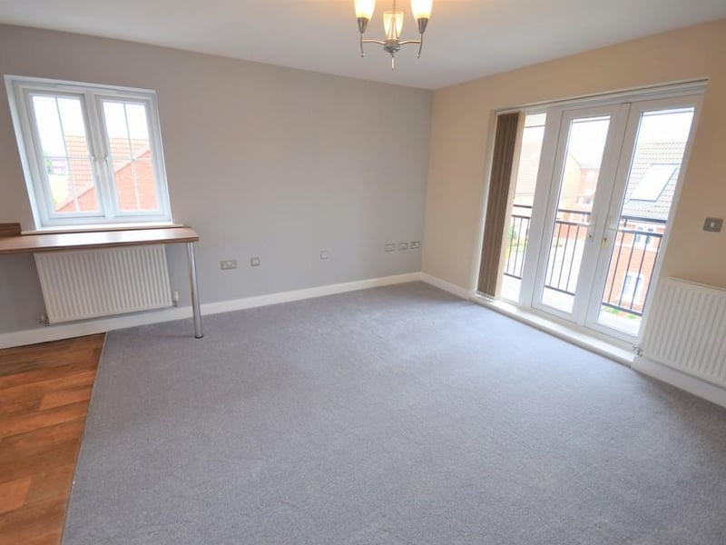 Living area with French doors opening on to balcony