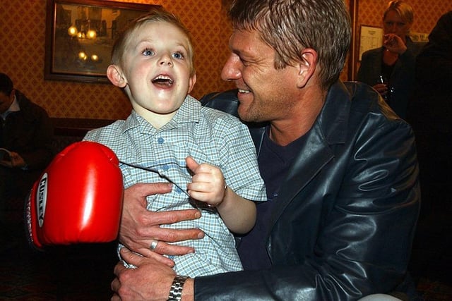 Young Sam Johnson from Handsworth throws a punch at Sean Bean who was at a charity boxing event held at Handsworth WMC to promote the Perthes Society... March 2003