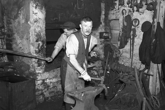 Work goes on at an Easington Lane Smithy in 1940.