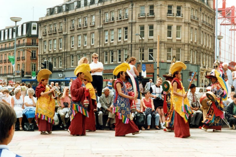 A Tibetan dance team performing on Fargate with Pinstone Street in the background during the World Student Games Cultural Festival. Ref no: t04691