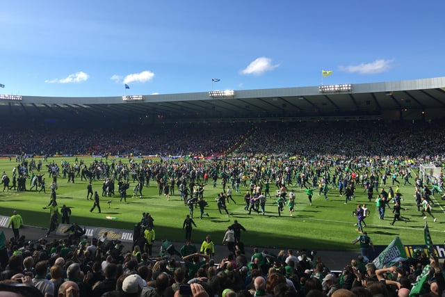 Hibs fans pour onto the Hampden turf to celebrate the end of 114 years of misery