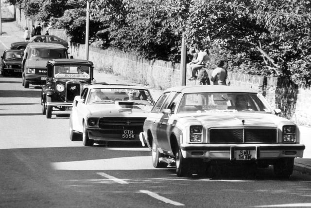 A line of cars heads to the Sheffield Motor Show & Family Gala at Graves Park in 1986