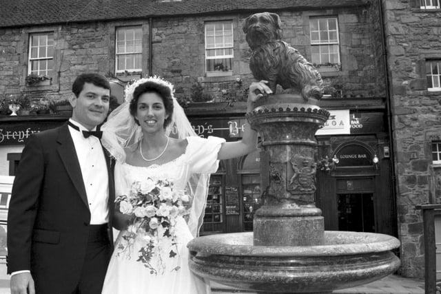 American couple Charles Eitel and Robin Young were married at Greyfriars Kirk in Edinburgh in July 1987 and posed for pictures beside Bobby.