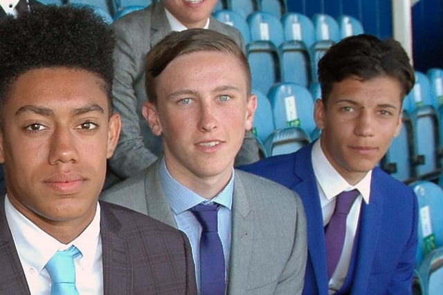 The midfielder poses with his team-mates after penning his apprenticeship in 2014.